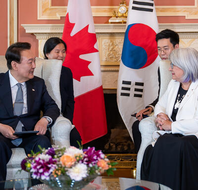 His Excellency Yoon Suk Yeol, President of the Republic of Korea, is seated across from the Governor General. Two people are seated behind them.
