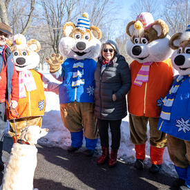 Governor General Simon and Mr. Whit Fraser stand next to the Winterlude Ice Hogs.