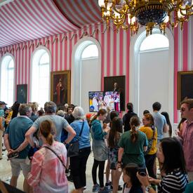Members of the public visit watch a livestream of the coronation during the Rideau Hall coronation event in Ottawa.